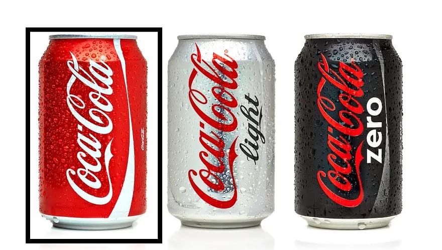 Three Coke soda cans lined up: classic, light, and zero.